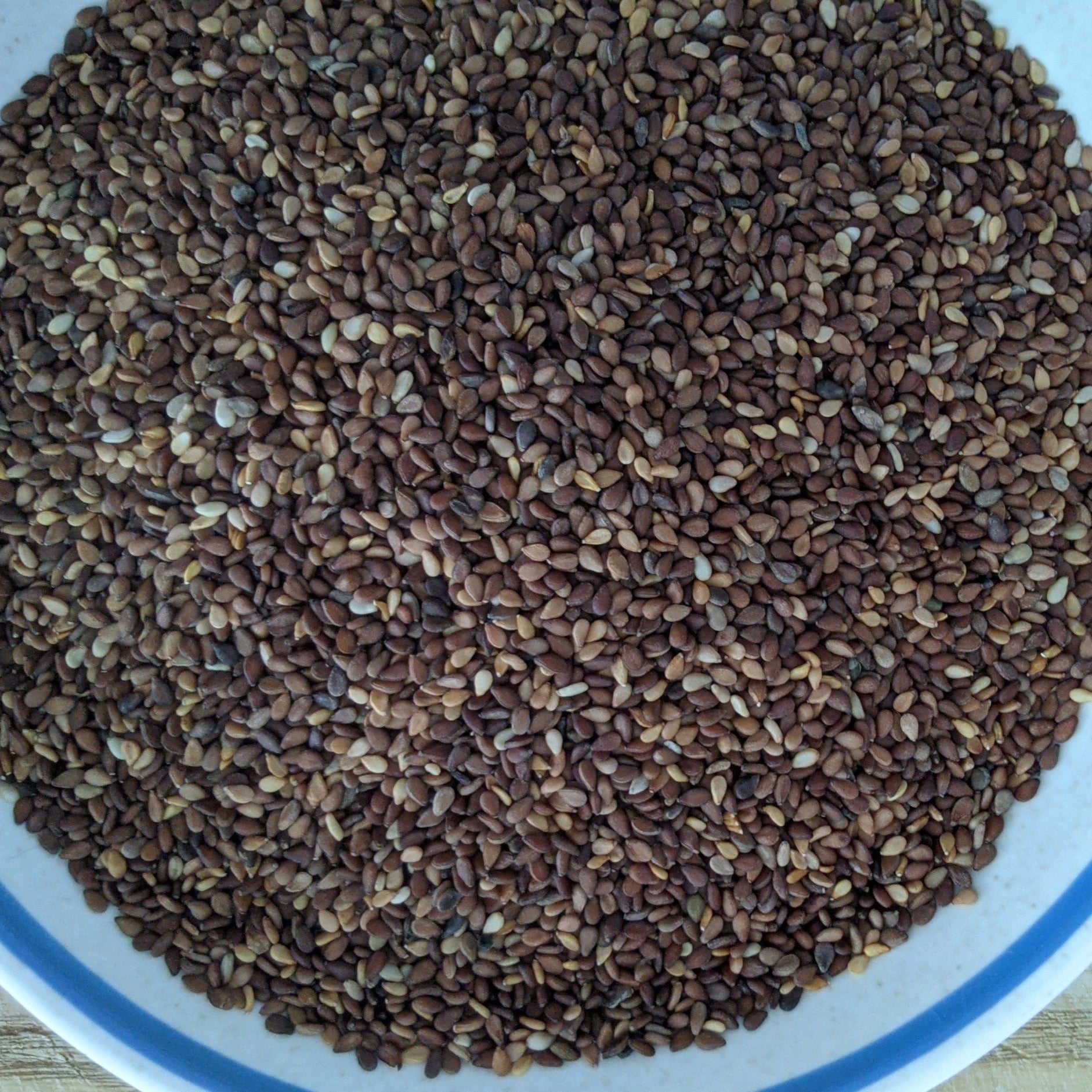A bowl of multicolor, brown benne sesame seeds